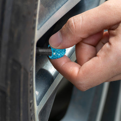 Blue rhinestone tire valve caps installed on car wheel
